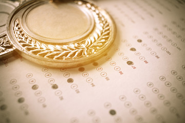 medals awards on exam test answer sheet, education and winner award concept, vintage tone