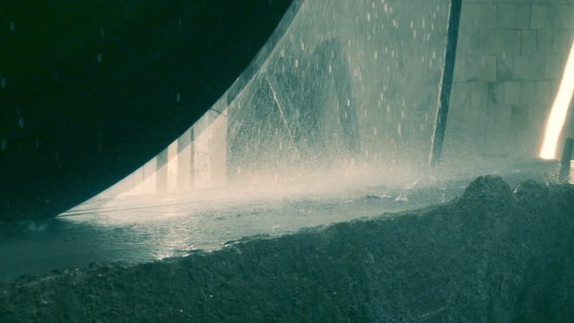 Close-up shot of a granite cutting by a circular saw, slow motion