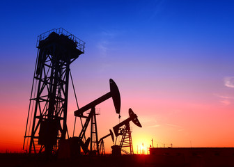 Pumping unit is working in oil field of the sunset
