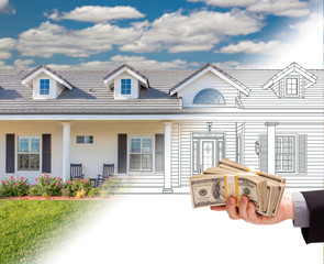 Hand Holding Stack of Money Over House Drawing Gradating Into Photograph.