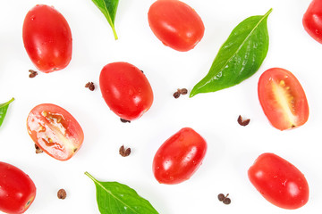 Cherry tomatoes with basil leaf on a white background