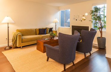 contemporary living room with green sofa and pair of wing chairs