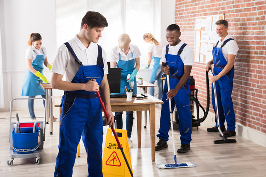 Diverse Janitors Cleaning The Office