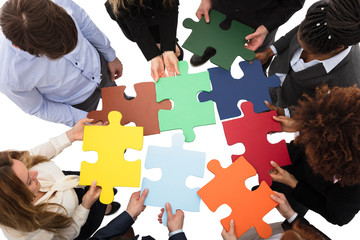 Businesspeople Solving Jigsaw Puzzle