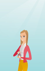 Insurance agent protecting model of house.