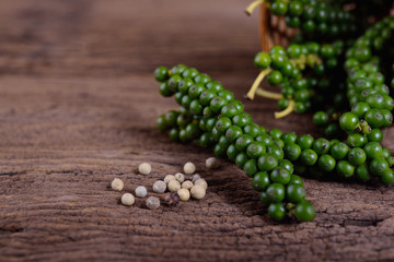 fresh and dried peppercorn on wooden table