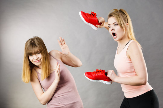 Agressive women fighting using shoes with female