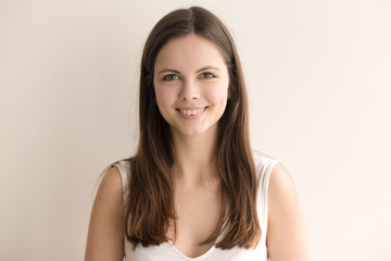 Headshot portrait of friendly young woman. Adorable teenager girl with happy facial expression...