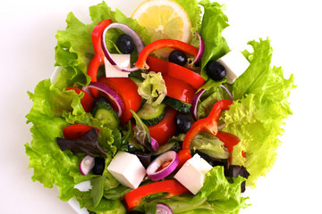 salad from fresh vegetables in a plate on a table, selective focus