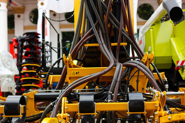 Close up of pipe system of hydraulic valves in agricultural machinery