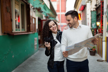 Fototapeta premium Handsome man and cute woman looking at map