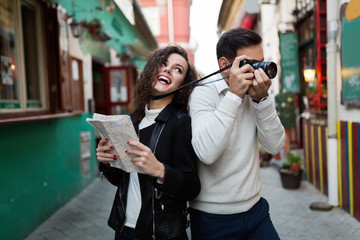 Young happy couple having fun with camera