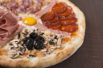 Hot pizza slice with melting cheese on a rustic wooden table. Fresh pizza with tomatoes, cheese and mushrooms on wooden table close up.