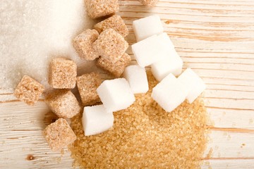 brown and white sugar on wooden background