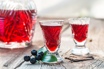 Clouseup of liqueur made of chokeberries and alcohol