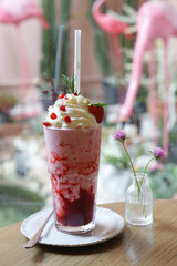 Strawberry Cheesecake Smoothie with strawberry sauce and topped with whipped cream, pomegranate seed, fresh strawberry and rosemary, It's thick and frosty for one tasty treat and refreshing.