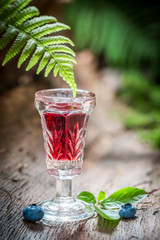 Sweet liqueur made of alcohol and blackberries in summer