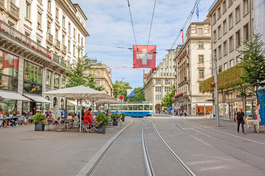 Zurich Shopping Street Bahnhofstrasse With Tram And Swiss Flag