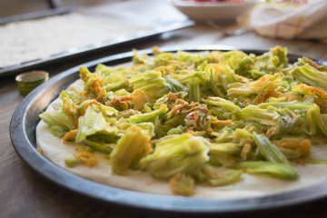 making pizza with zucchini flowers
