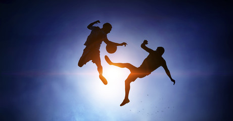 Silhouettes of two soccer players