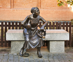 Statue of tradeswoman at new Market Square in Torun.  Poland