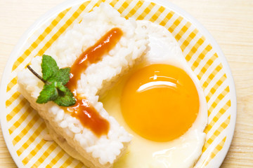 plate of rice with egg and tomato sauce.
