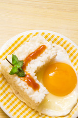 plate of rice with egg and tomato sauce.