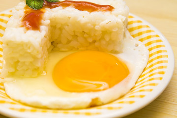 plate of rice with egg and tomato sauce.
