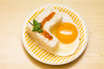 plate of rice with egg and tomato sauce.