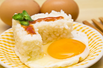 plate of rice with egg and tomato sauce.
