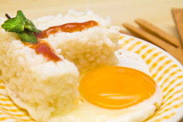 plate of rice with egg and tomato sauce.