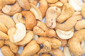 Roasted salted cashews, isolated on a white background