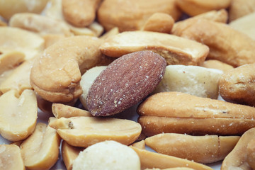 Salted cocktail nuts on a white background