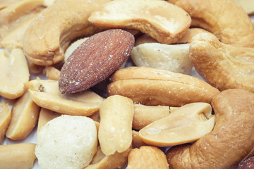 Salted cocktail nuts on a white background