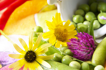 Green peas on tablecloth with flowers