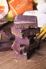 Pieces of chocolate on wood
