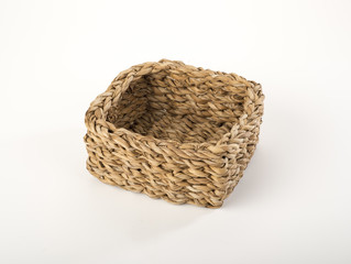 Braided straw basket isolated on white background