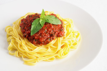 pasta with sauce made of tomatoes, parsley, and basil