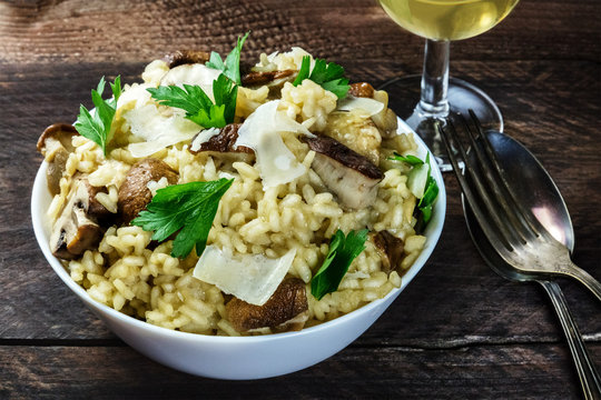 Photo of mushroom risotto with glass of white wine