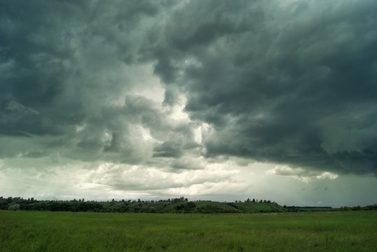 Fototapeta Clouds and rain over fields and forests