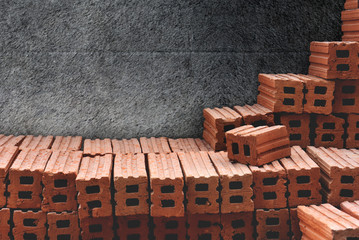 Brick Stack Isolated on Cement Concrete wall background with Clipping Path, Building Work space,...