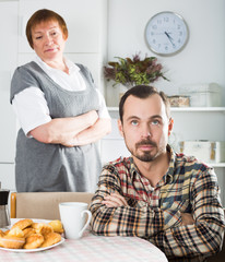 Elderly mother teaches her son
