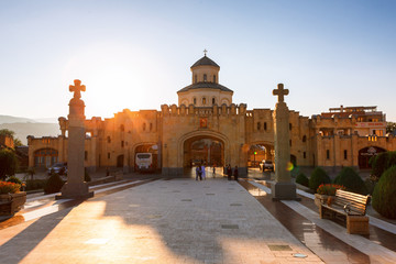 Fototapeta na wymiar Tbilisi, Georgia - 8 October 2016: sunset view on Main gates entrance and cross to Tbilisi Sameba Cathedral (Holy Trinity) biggest Orthodox Cathedral in Caucasus