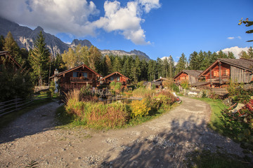 Fototapeta na wymiar Idyllic chalets in the Alps, in the midst of alpine mountain landscape