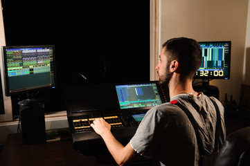 A lighting engineer works with lights technicians control on the concert show. Professional light...