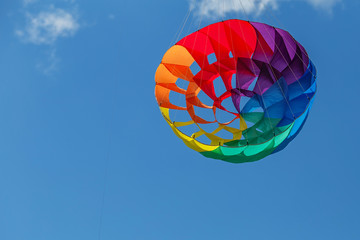 kites flying in a blue sky. Kites of various shapes.