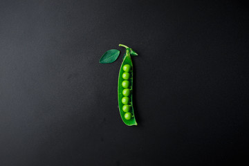 green peas on a black background.