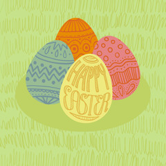 Happy Easter card with 4 eggs in a pile. Green grass background.