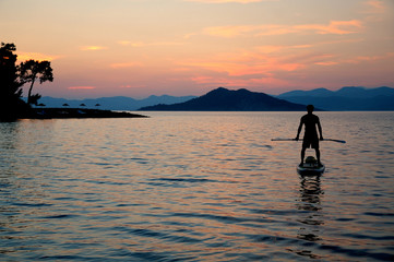 Man on SUP at sunset