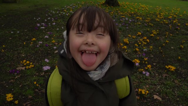 Down syndrome girl smiling and laughing and show the language